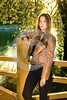 Portrait of beautiful girl at sunset in the autumn