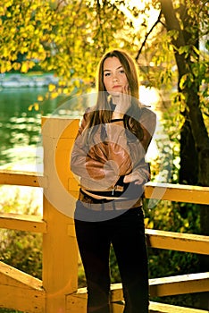 Portrait of beautiful girl at sunset in the autumn