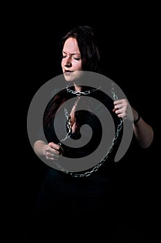 Portrait of beautiful girl tied in chains