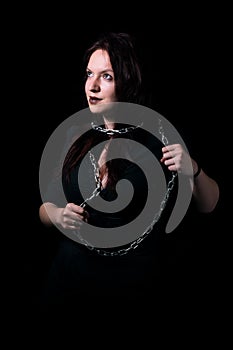 Portrait of beautiful girl tied in chains