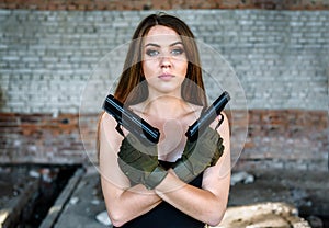 Portrait of beautiful girl with two guns