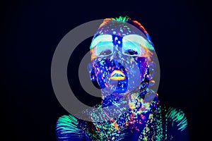 Portrait of beautiful girl with ultraviolet paint on her face