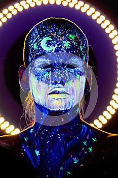 Portrait of beautiful girl with ultraviolet paint on her face