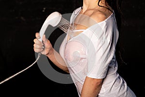 Portrait of the beautiful girl under shower over white