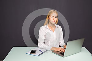 Portrait of beautiful girl using laptop at workplace. Project concept