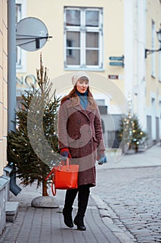 Portrait of beautiful girl walking on street in old town Tallinn