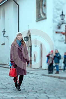 Portrait of beautiful girl walking on street in old town Tallinn