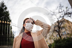 Portrait of beautiful girl wearing protective medical mask