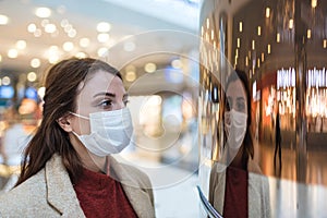 Portrait of beautiful girl wearing protective medical mask