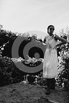 Portrait of a beautiful girl in a white dress in the garden. Burnette beautiful natural girl with in a white dress in