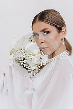 Portrait of a beautiful girl with white flowers.