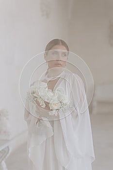 Portrait of a beautiful girl with white flowers.