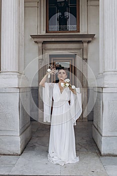 Portrait of a beautiful girl with white flowers.