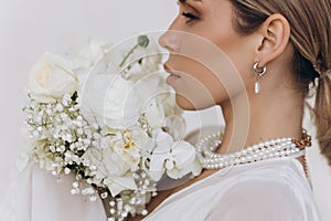 Portrait of a beautiful girl with white flowers.