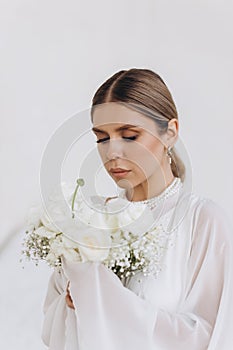 Portrait of a beautiful girl with white flowers.
