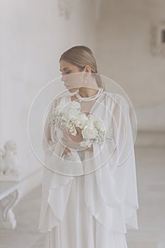 Portrait of a beautiful girl with white flowers.