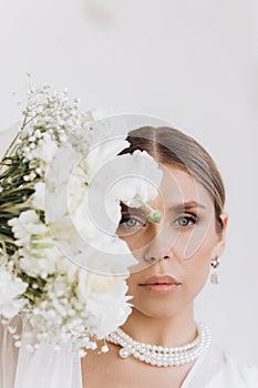 Portrait of a beautiful girl with white flowers.