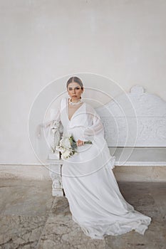 Portrait of a beautiful girl with white flowers.