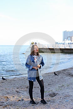 Portrait of beautiful girl who poses and smiles at camera, stand