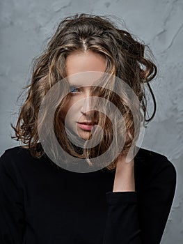 Portrait of beautiful girl with wild curly hair