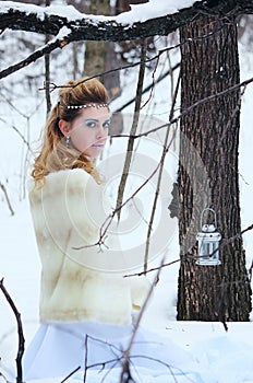 Portrait of beautiful girl in the winter forest