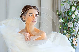 Portrait of a beautiful girl wrapped in white angel wings