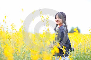 Portrait of the beautiful girl with yellow flowers,sunny summer