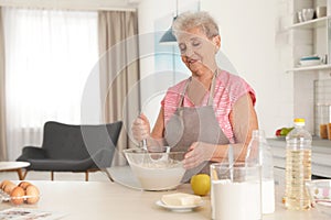 Portrait of beautiful grandmother cooking