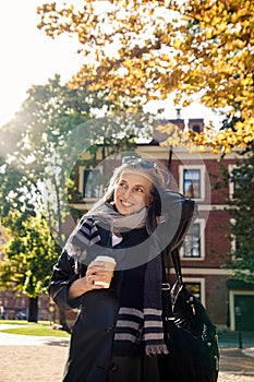 Portrait of  beautiful gray-haired elderly woman in  park on  bench