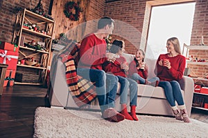 Portrait of beautiful handsome adorable family wife husband sitting on sofa talking having fun at decorated loft home