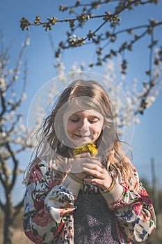 portrait of beautiful happy child in spring nature, relaxing and having good time