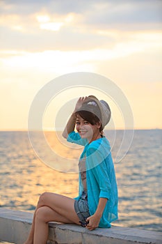 Portrait of beautiful and happy emotion teenager wearing straw h