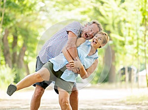 Portrait of a beautiful happy senior couple in love relaxing in the park