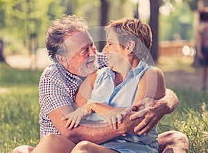 Portrait of a beautiful happy senior couple in love relaxing in the park