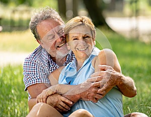 Portrait of a beautiful happy senior couple in love relaxing in the park