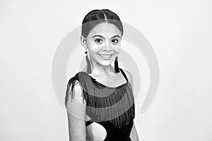 Portrait of beautiful happy smiling teenage girl on yellow studio background.