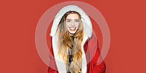 Portrait of a beautiful happy smiling woman celebrate winter Christmas holidays isolated on red background. Young