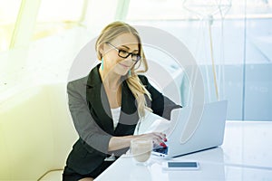 Portrait of beautiful happy smiling young office woman working o