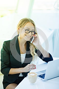 Portrait of beautiful happy smiling young office woman working o