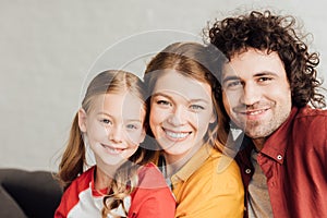 portrait of beautiful happy young family smiling