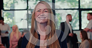 Portrait of beautiful happy young female business coach, company CEO executive smiling at camera at office slow motion.