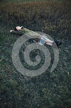 Portrait of beautiful hippie girl lying on the grass