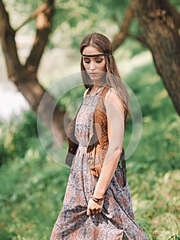 Beautiful hippie girl on spring forest background