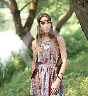 Beautiful hippie girl on spring forest background