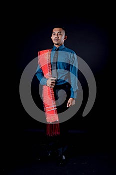 Portrait of beautiful indonesian man wearing traditional batak costume