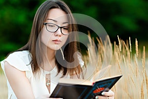 Portrait beautiful korean girl reading book outdoors