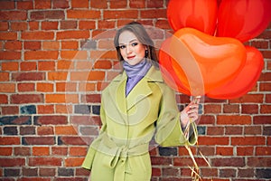 Portrait of beautiful lady with red air balloons