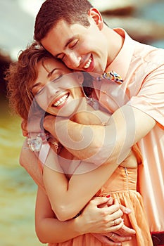 Portrait of a beautiful laughing smiling couple of hipsters in trendy clothing. Wedding day. Close up.