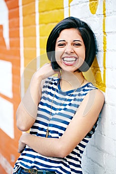 Portrait of beautiful laughing young hipster brunette latin hispanic girl woman with short hair bob