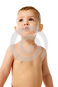 Portrait of beautiful little baby boy, child standing with curious look isolated over white studio background